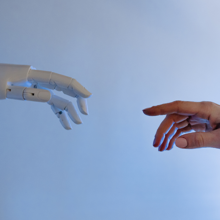 Human hand reaching for robotic hand