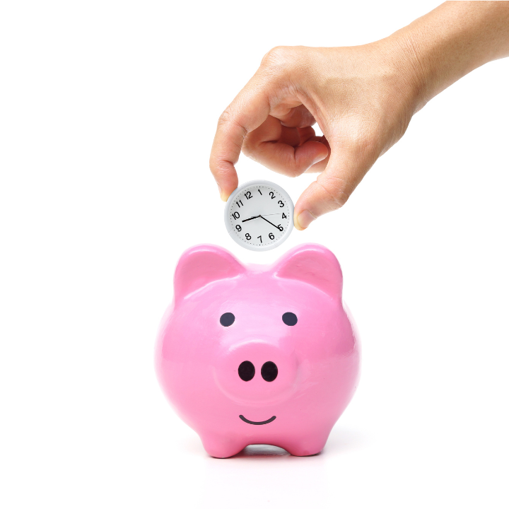 Piggy bank with someone dropping a small clock in rather than a coin