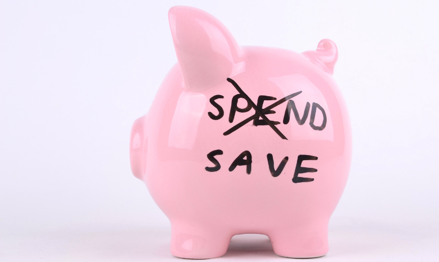 Piggy bank with spend crossed out and save written