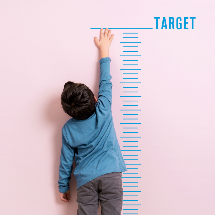 Height chart and child reaching to the word 'target'